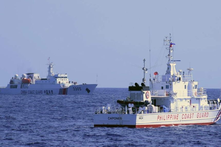 A Chinese coast guard ship (L) shadowing a Philippine coast guard vessel (R) while conducting a maritime patrol in the SCS 
