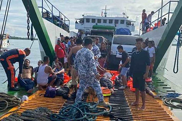 Rescued passengers sit on another ferry