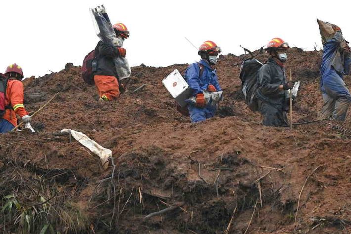 Rescue workers sift debris at crash site of flight MU5375