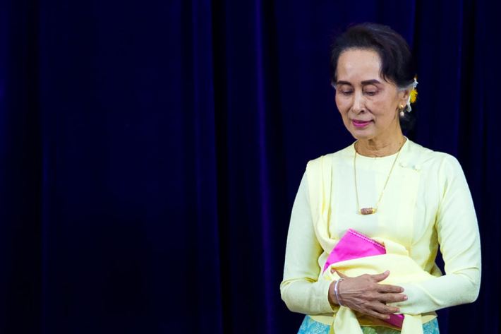 Aung San Suu Kyi leaves after delivering an address before students of Yangon University