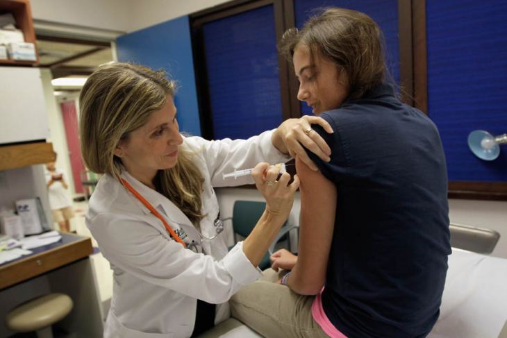 Girl receiving a HPV vaccine shot