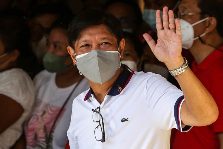 Marcos Jr gestures to the crowd after casting his vote