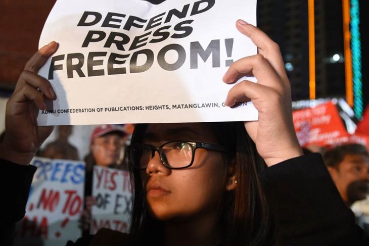A protestor holds a placard in Manila