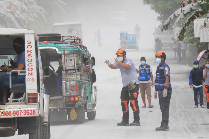 Disaster management officers guide traffic