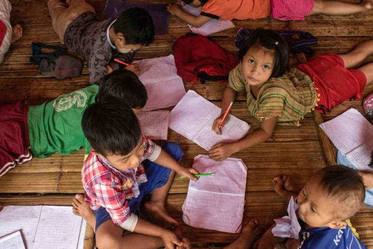 Children attend a class in a temporary shelter at a camp in Kayah state