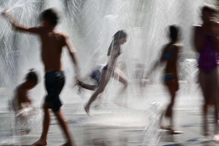 Children cool off in a fountain
