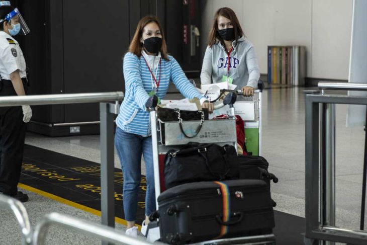 Passengers arrive at the Hong Kong International Airport
